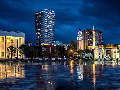 Night view of Skanderbeg Square with illuminated Maritim Hotel Plaza Tirana in the background