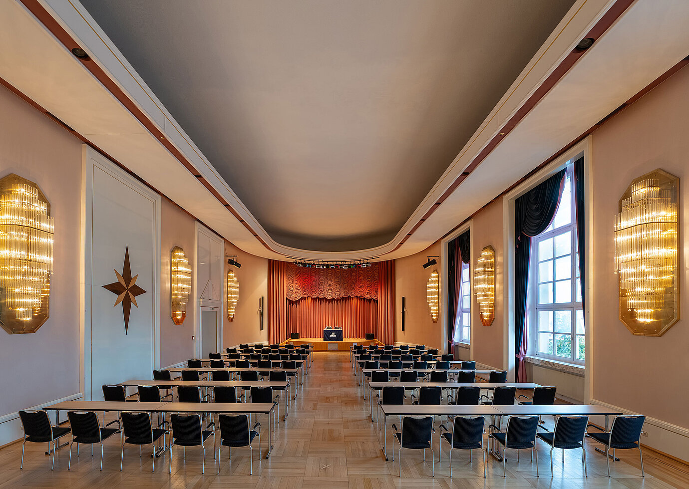 Waldeck Hall at Maritim Hotel Bad Wildungen with long row seating, stage and elegant lighting.