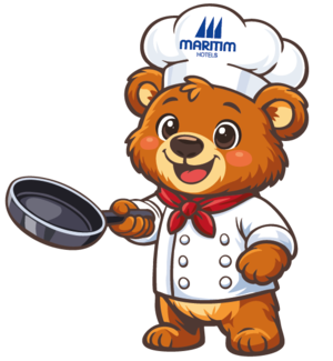 Maritim bear as a chef Cartoon bear in a chef outfit holding a frying pan and wearing a Maritim chef’s hat.