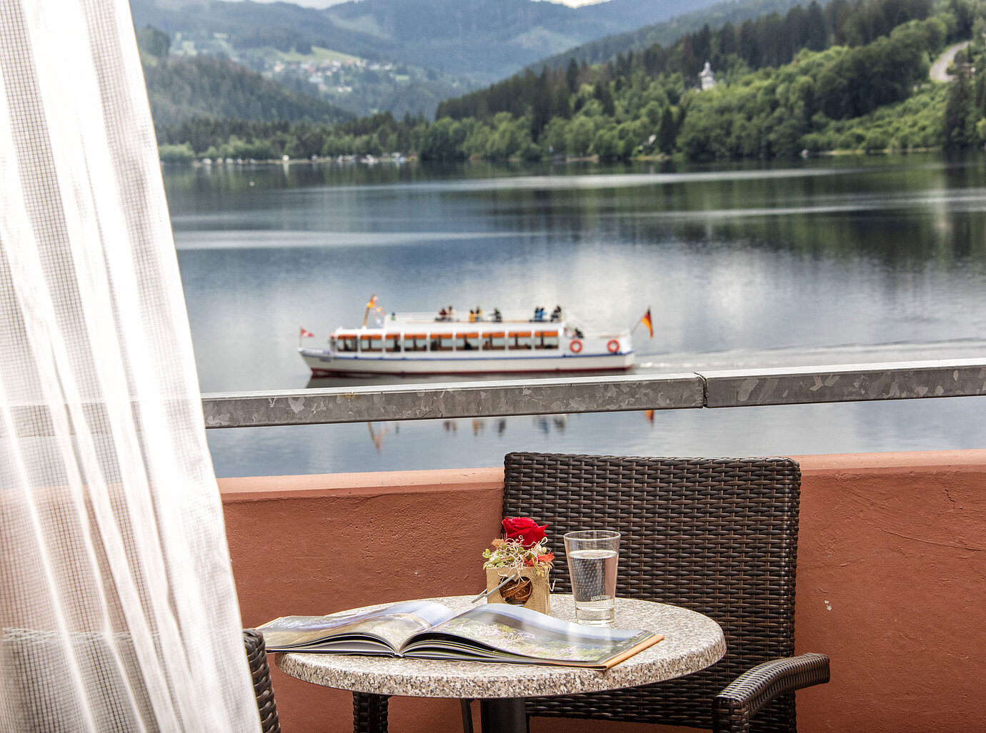 Balcony with lake view and passing boat on Lake Titisee at Maritim TitiseeHotel