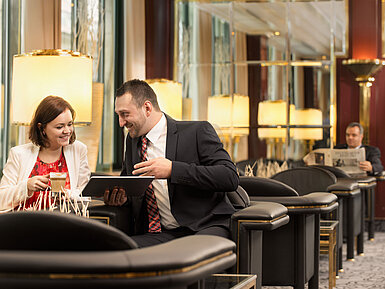 Two business guests chatting over coffee in the lounge at Maritim Hotel Stuttgart