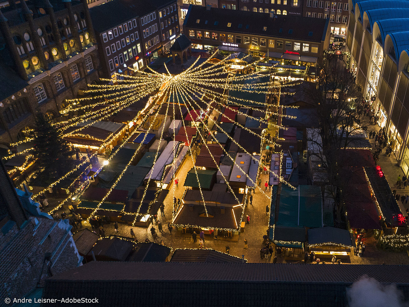 Illuminated Christmas market Lübeck from above with stalls and festive lights in the city