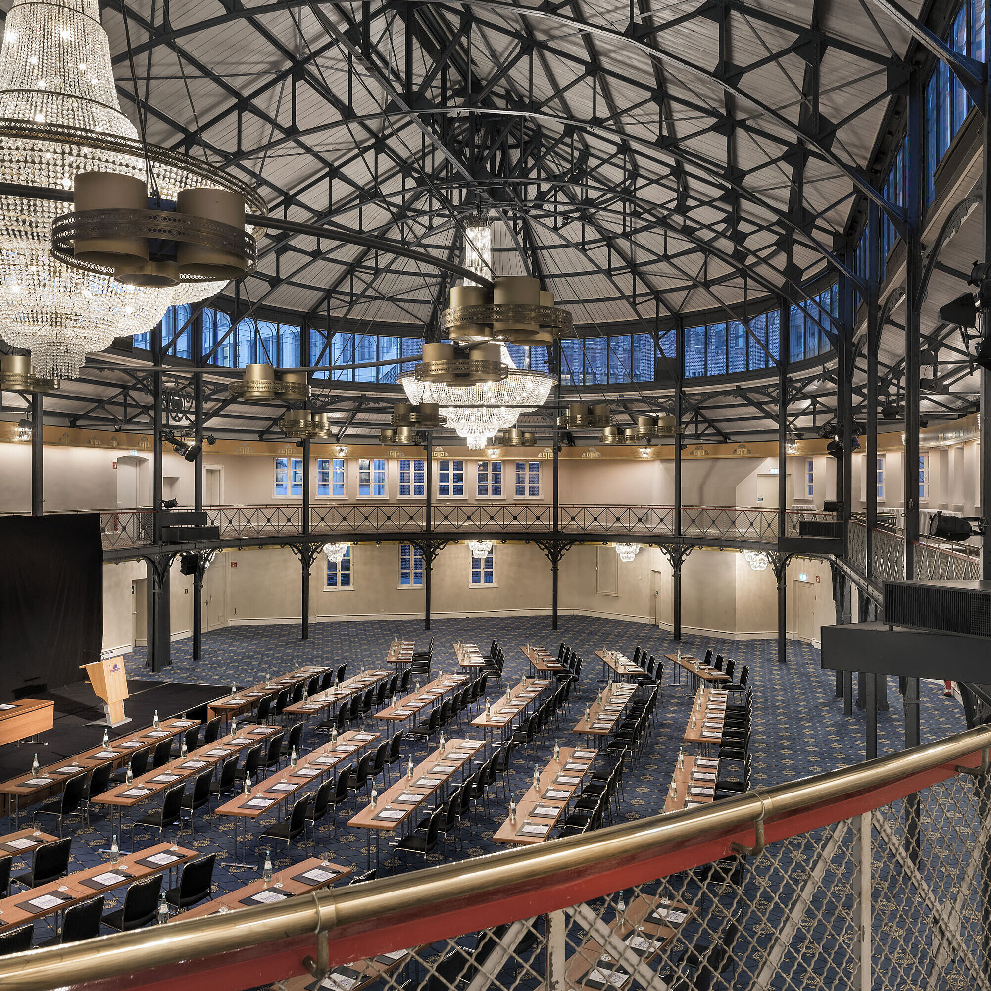Historic riding hall with stage, chandeliers and seating rows at Maritim Hotel Stuttgart