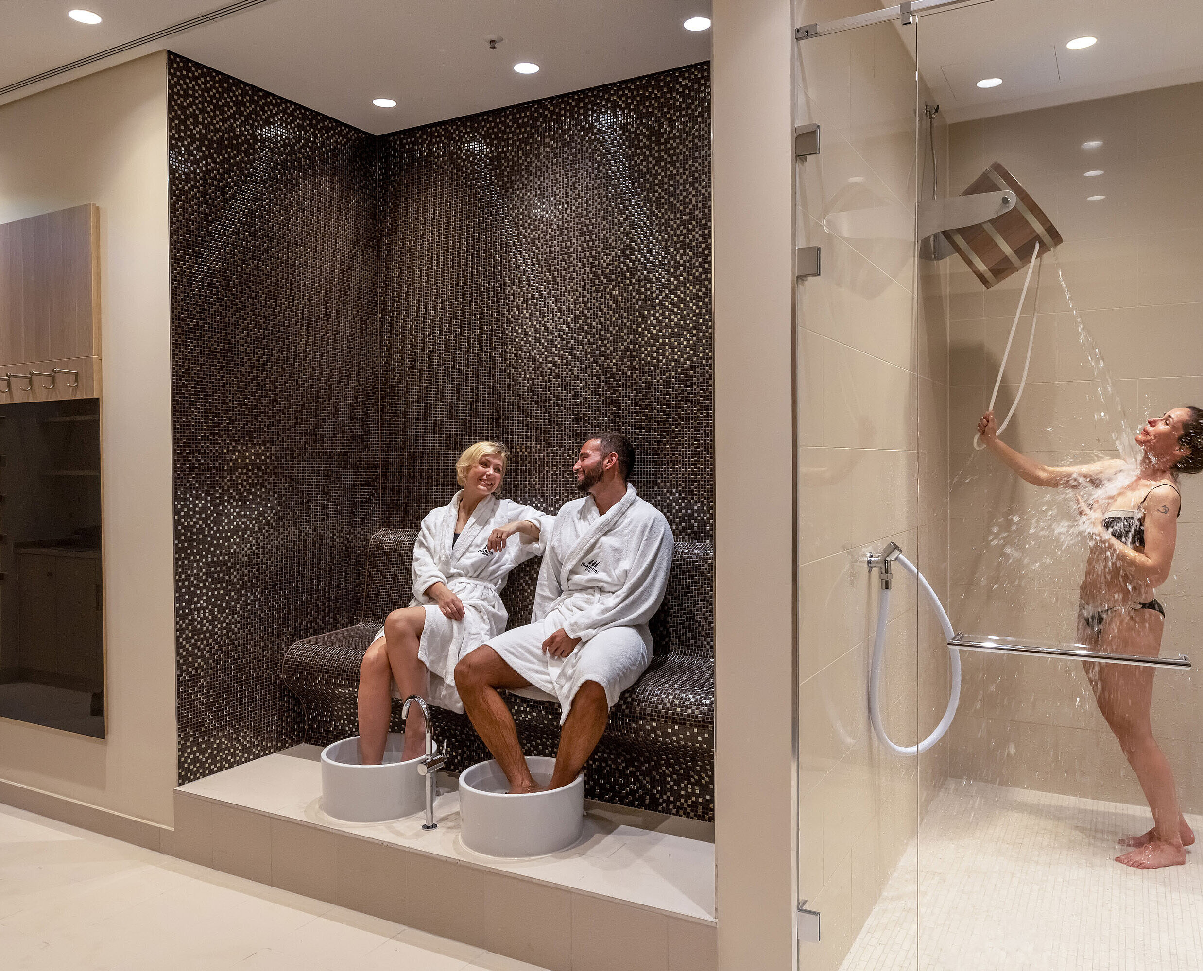 Sauna Wellness area at Maritim Hotel Ingolstadt with foot baths, experience shower, and relaxing atmosphere.