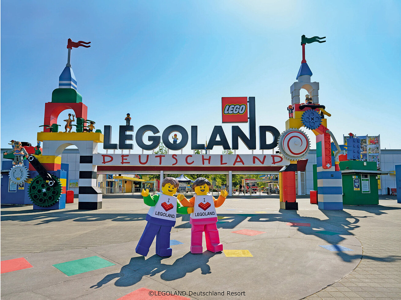 Entrance Area of LEGOLAND® Deutschland Resort Colorful entrance of LEGOLAND® Deutschland Resort with giant LEGO® figures and blue sky.