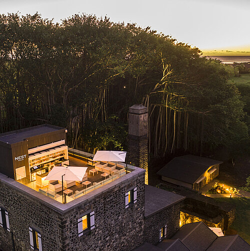 Une terrasse stylée sur le toit de l'hôtel avec des sièges confortables et une vue imprenable sur le coucher du soleil