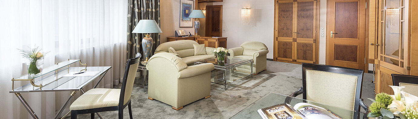 Suite Luxury  Suite spaziosa con arredi eleganti, tavolo in vetro e salotto accogliente al Maritim Hotel Magdeburg