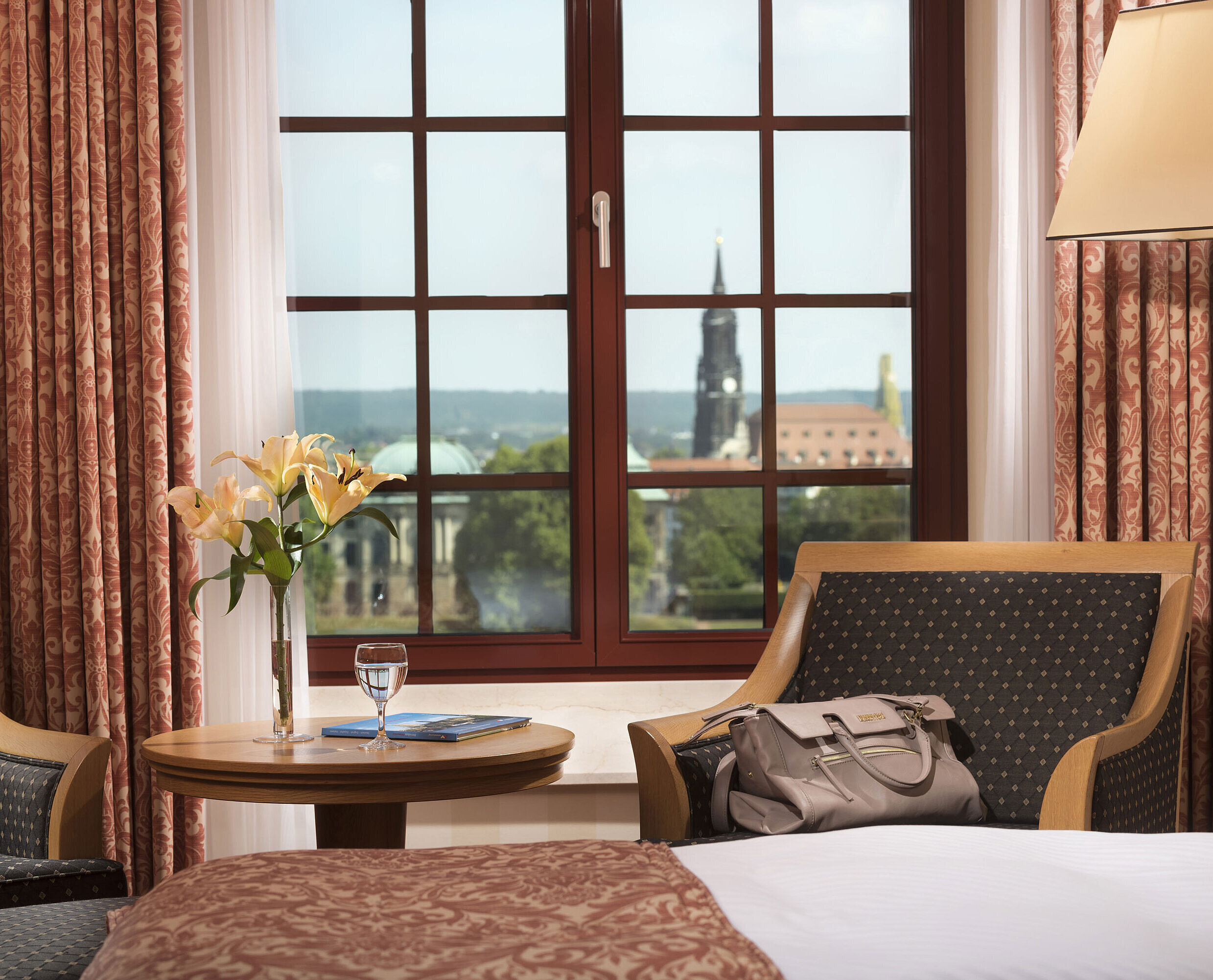 Superior room Seating area in the Superior room at Maritim Hotel Dresden with a window view of the historic old town.