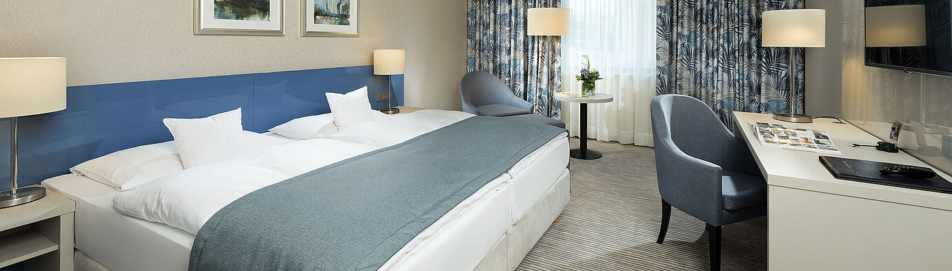 Superior room  Superior room at Maritim Hotel Bonn with stylish design, cozy beds, modern desk, and comfortable seating area.