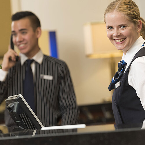 Smiling staff at the reception of Maritim Hotel Bad Homburg offer a warm welcome.