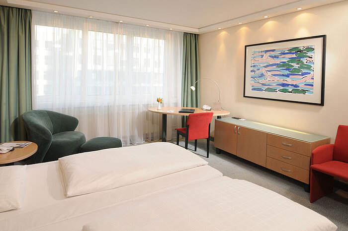 Chambre double confortable à l'hôtel Maritim proArte Berlin avec design moderne et bureau.