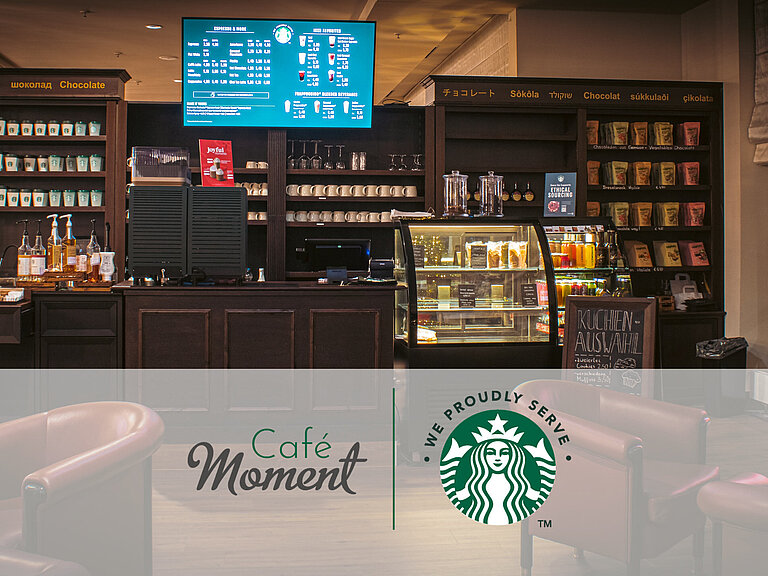 Café (proudly serves Sturbucks) Café at the Maritim Hotel Bonn with Starbucks coffee, snack counter, cake display and cosy seating in a modern setting