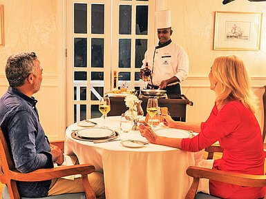 Couple enjoying an exclusive dinner with live cooking at the table