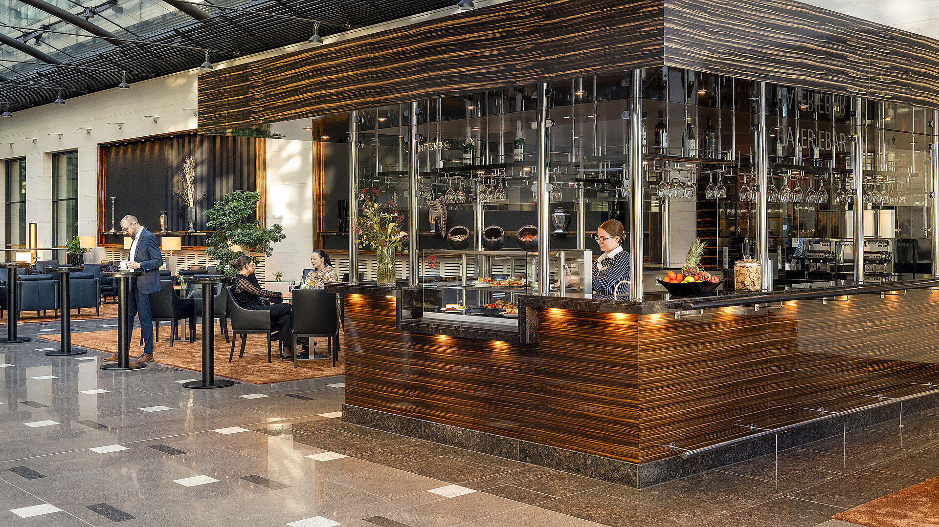 Café Moment Modern Café at Maritim Hotel Düsseldorf with elegant design, cozy seating areas, and a staff member behind the counter