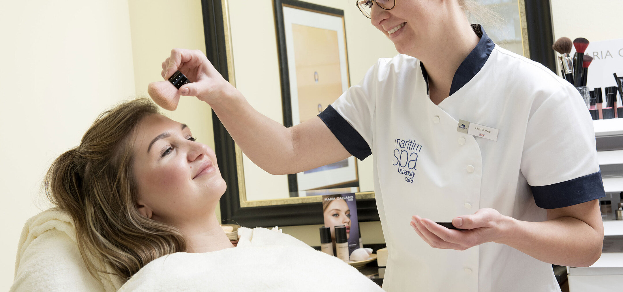 Esteticista aplicando polvo durante un tratamiento de belleza en el spa del Maritim Seehotel Timmendorfer Strand.