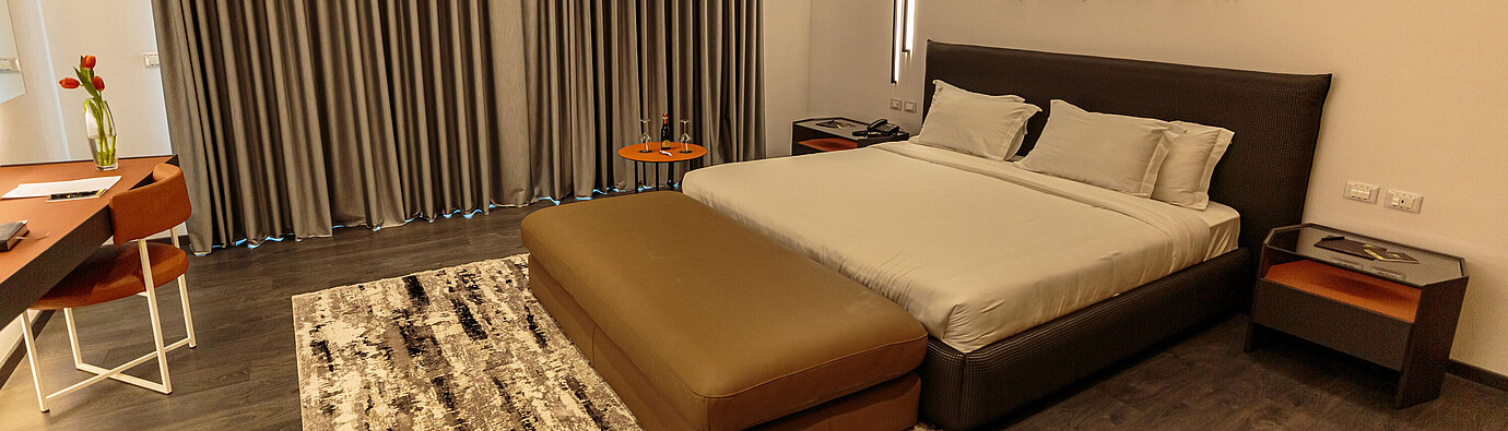 Habitación doble moderna en Maritim Resort Marina Bay con cama grande, escritorio y diseño elegante