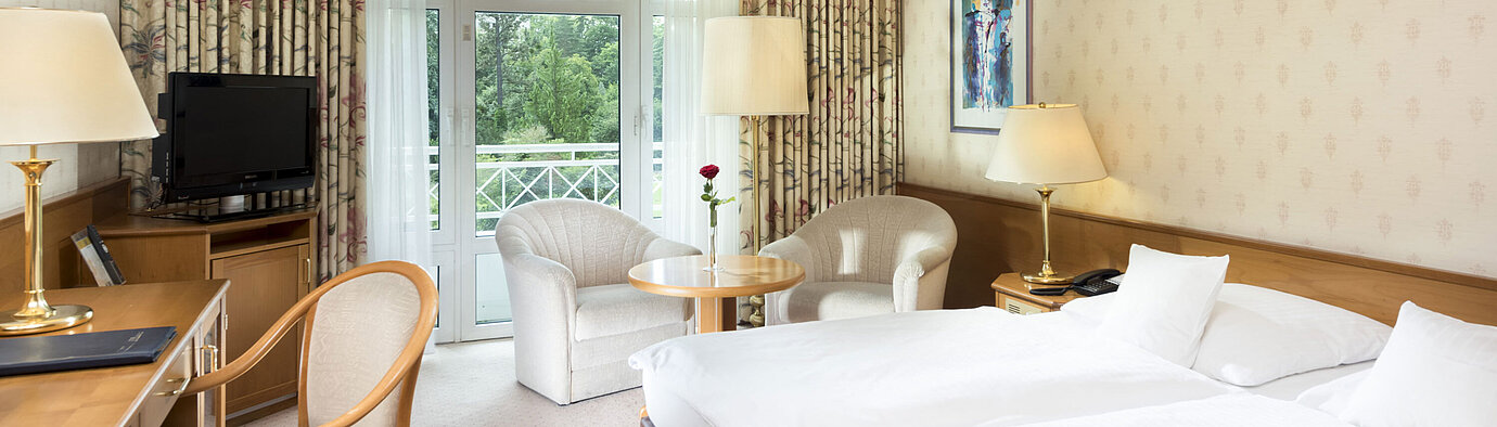 Chambre double lumineuse avec balcon et coin salon au Maritim Hotel Bad Wildungen