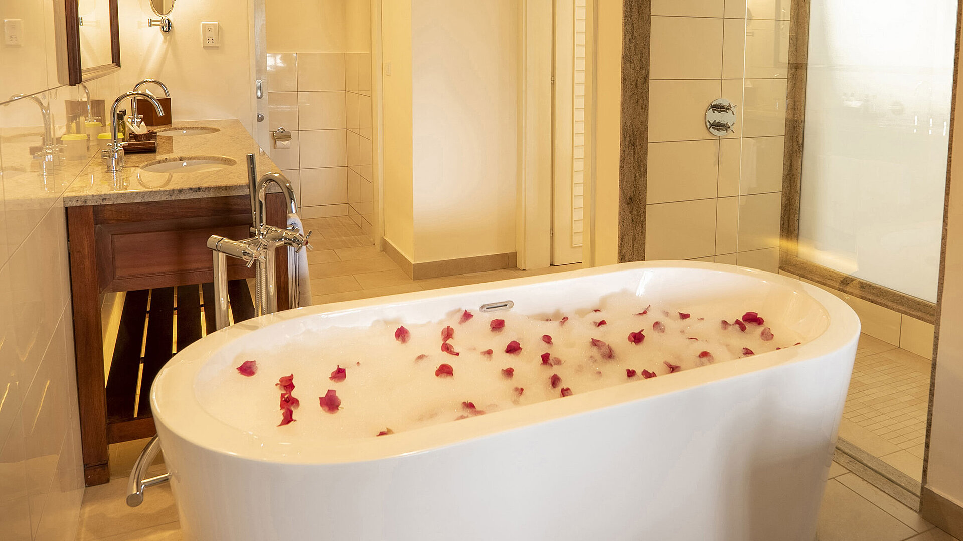Grand Deluxe Garden View room Bathroom with freestanding bathtub, shower area, and luxurious amenities