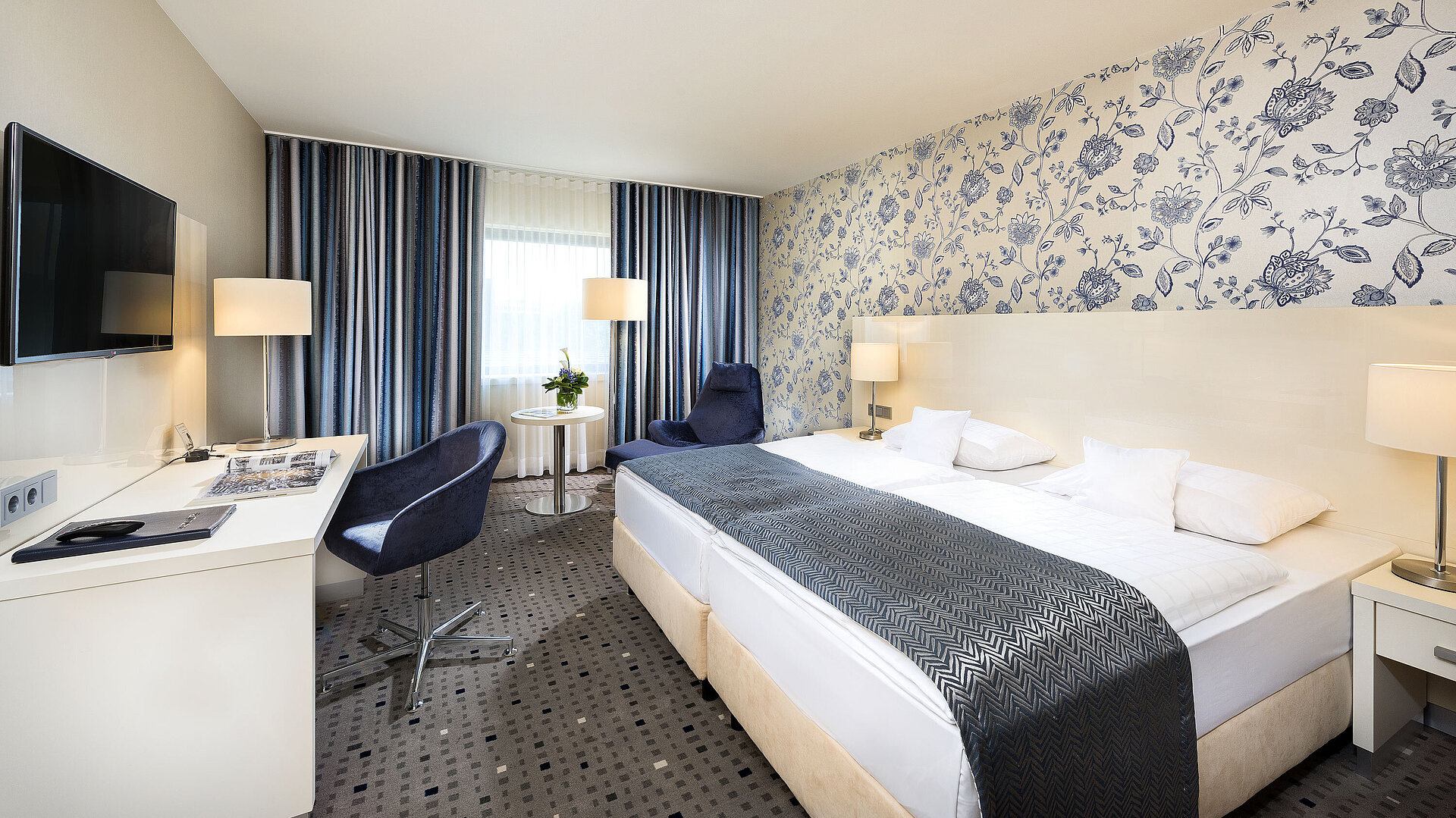 Superior room at Maritim Hotel Bonn with modern design, cozy bed, desk, and stylish curtains. 