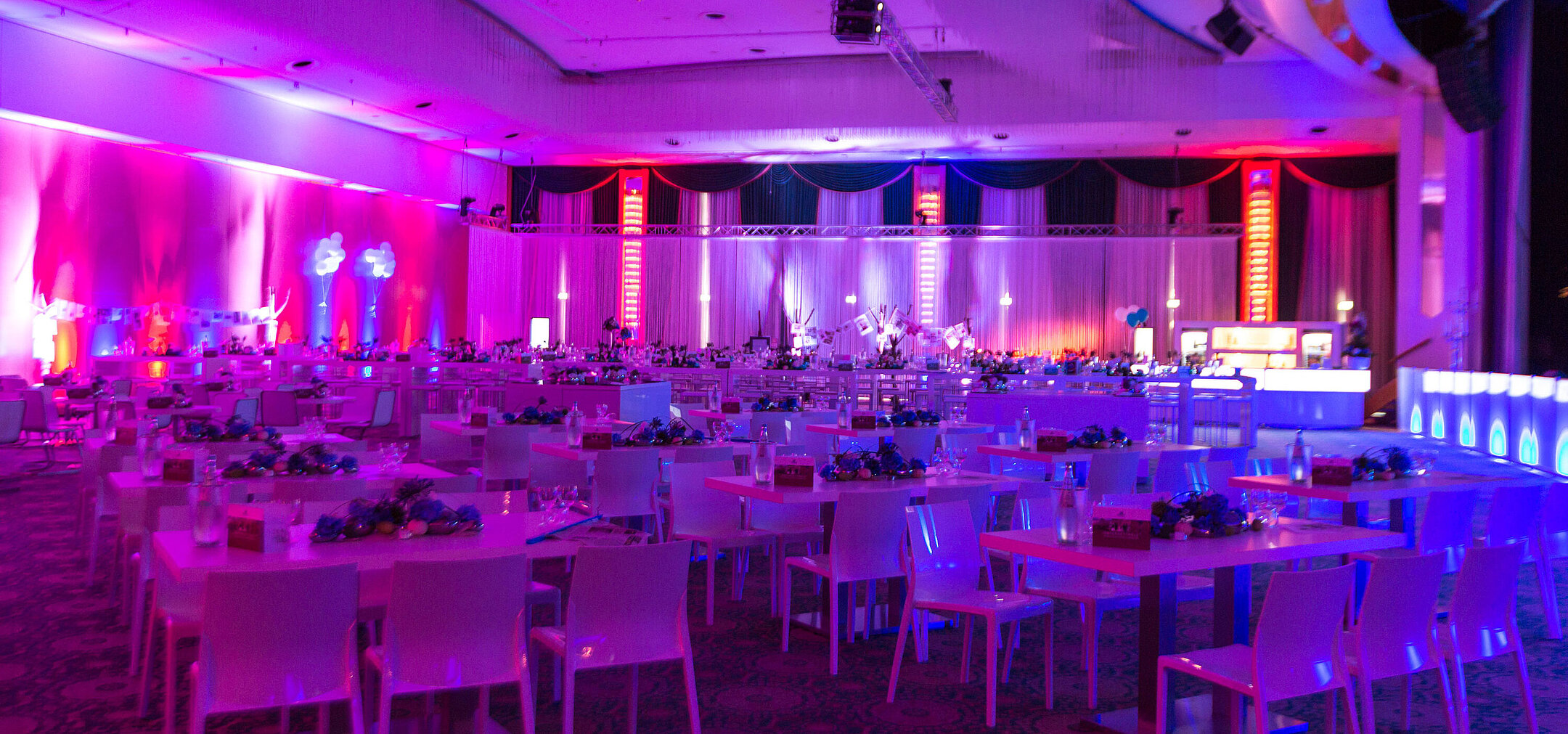 Meeting room An elegant event venue at Maritim Hotel with festively set tables and atmospheric lighting for events.