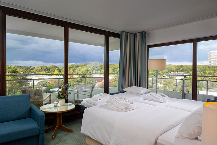 SuperiorPlus Family room Parkside SuperiorPlus Family Room facing the park with double bed, seating area and large windows overlooking the greenery