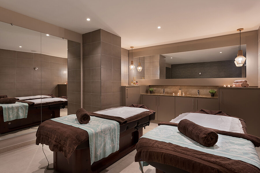 Elegant spa area at Maritim Antonine Hotel & Spa Malta with two massage beds, a warm ambience and a relaxing atmosphere.
