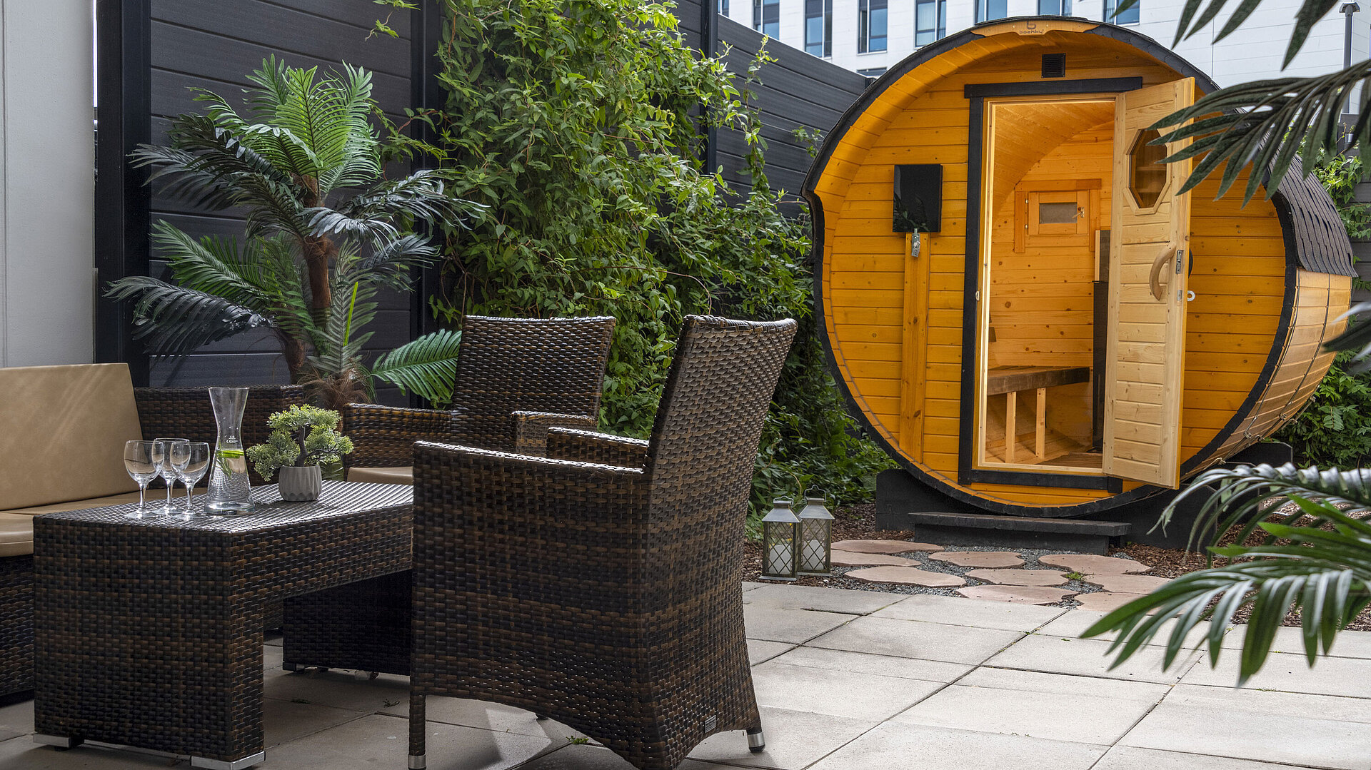 Cosy outdoor area with seating and barrel sauna at Maritim Hotel Travemünde