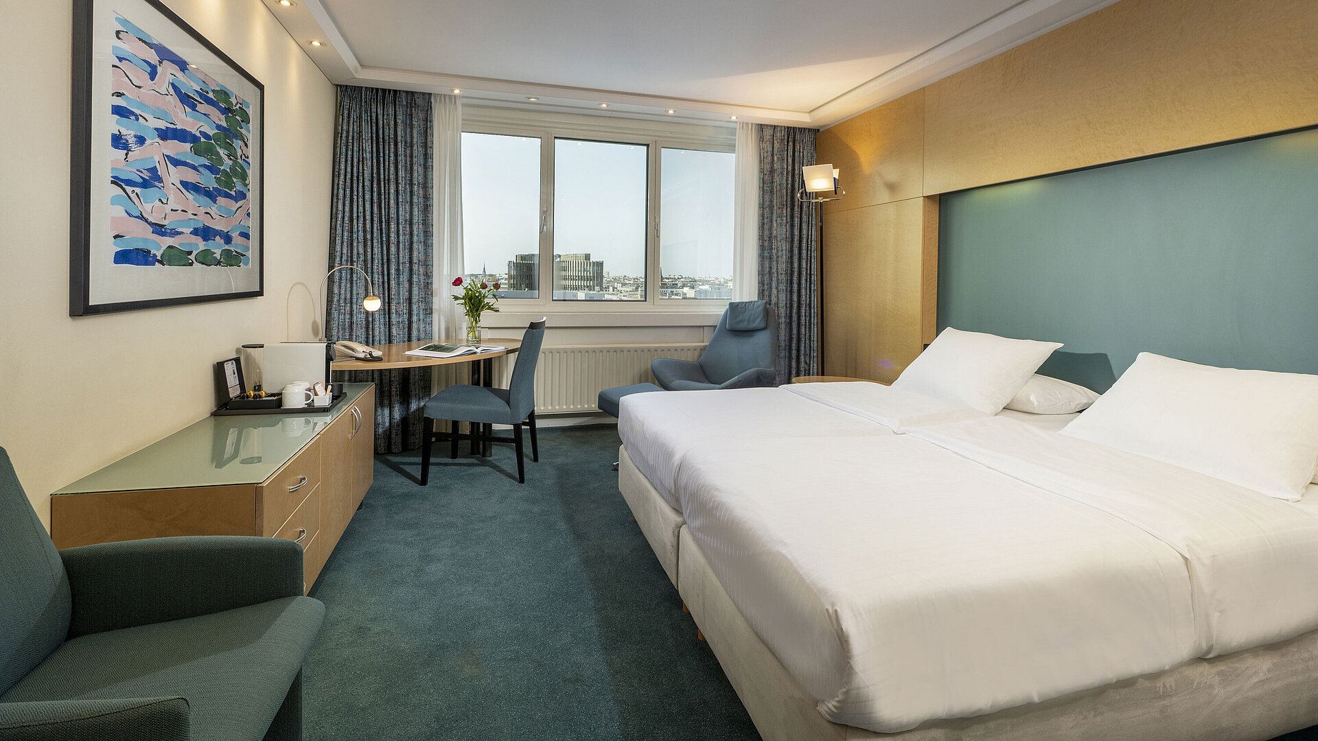 Modernly furnished Superior room at Maritim proArte Hotel Berlin with large bed, desk, artwork, and city view from the window
