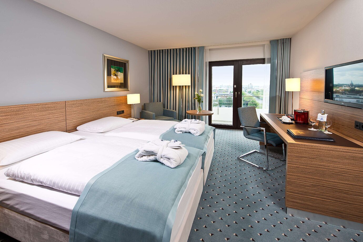 Superior room at Maritim Hotel Darmstadt featuring stylish design, desk, cozy seating area, and double bed with bathrobes.