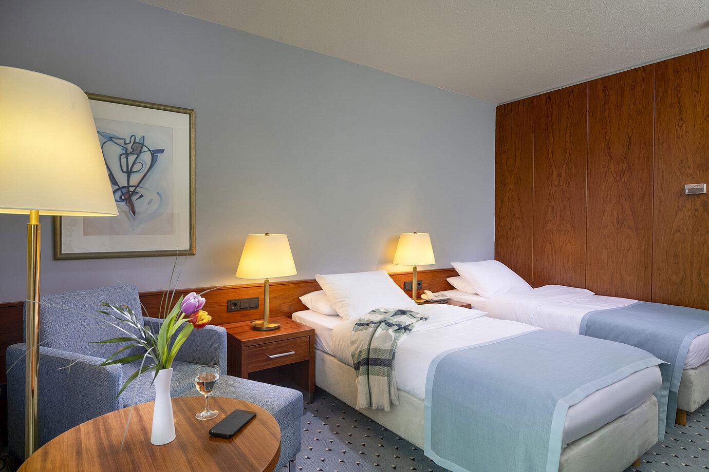 Comfort twin room at Maritim Hotel Darmstadt with two single beds, cozy seating area, and elegant interior design.