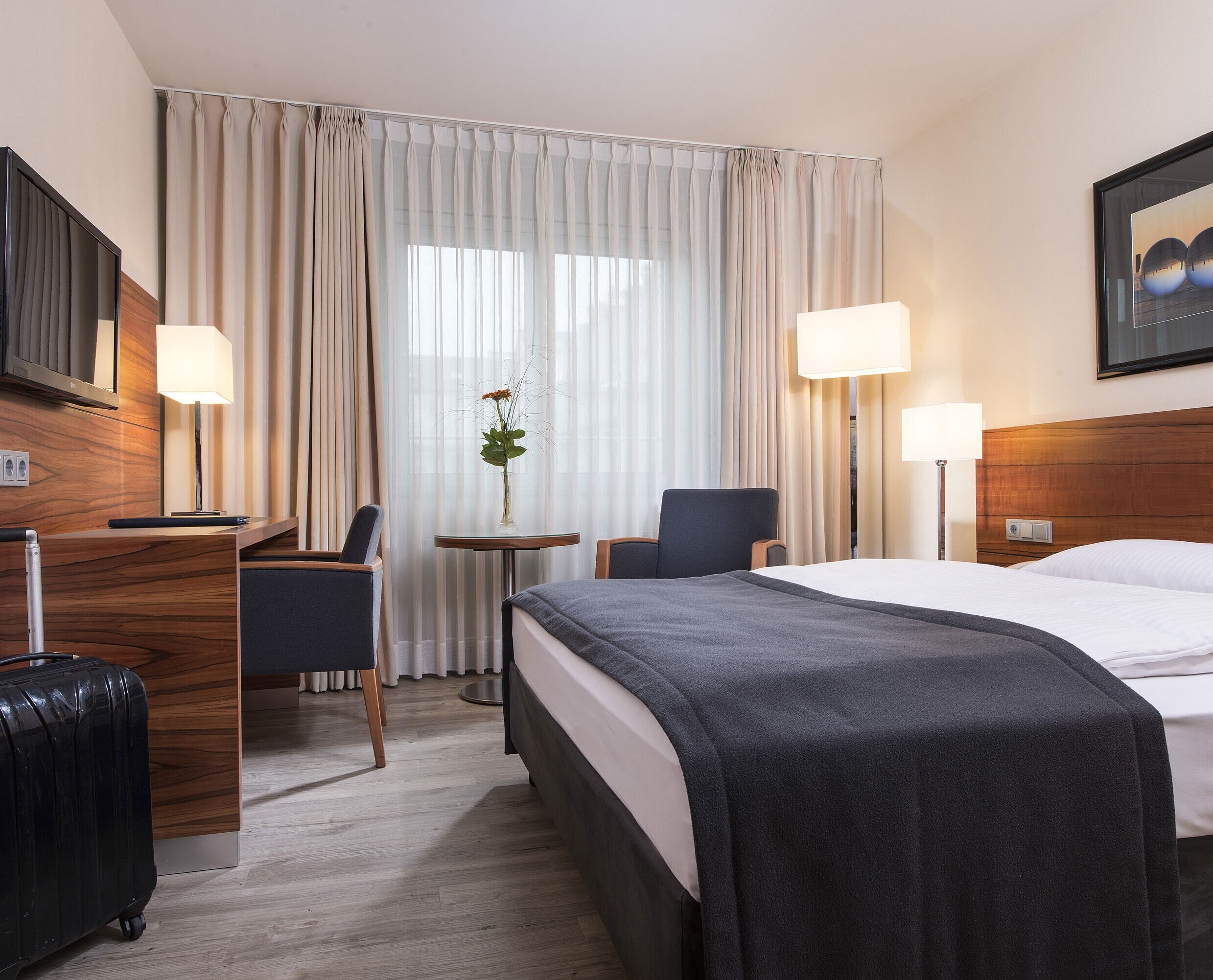 Camera d'albergo per chi soffre di allergie Camera accogliente con letto doppio, scrivania e valigia al Maritim Hotel Monaco