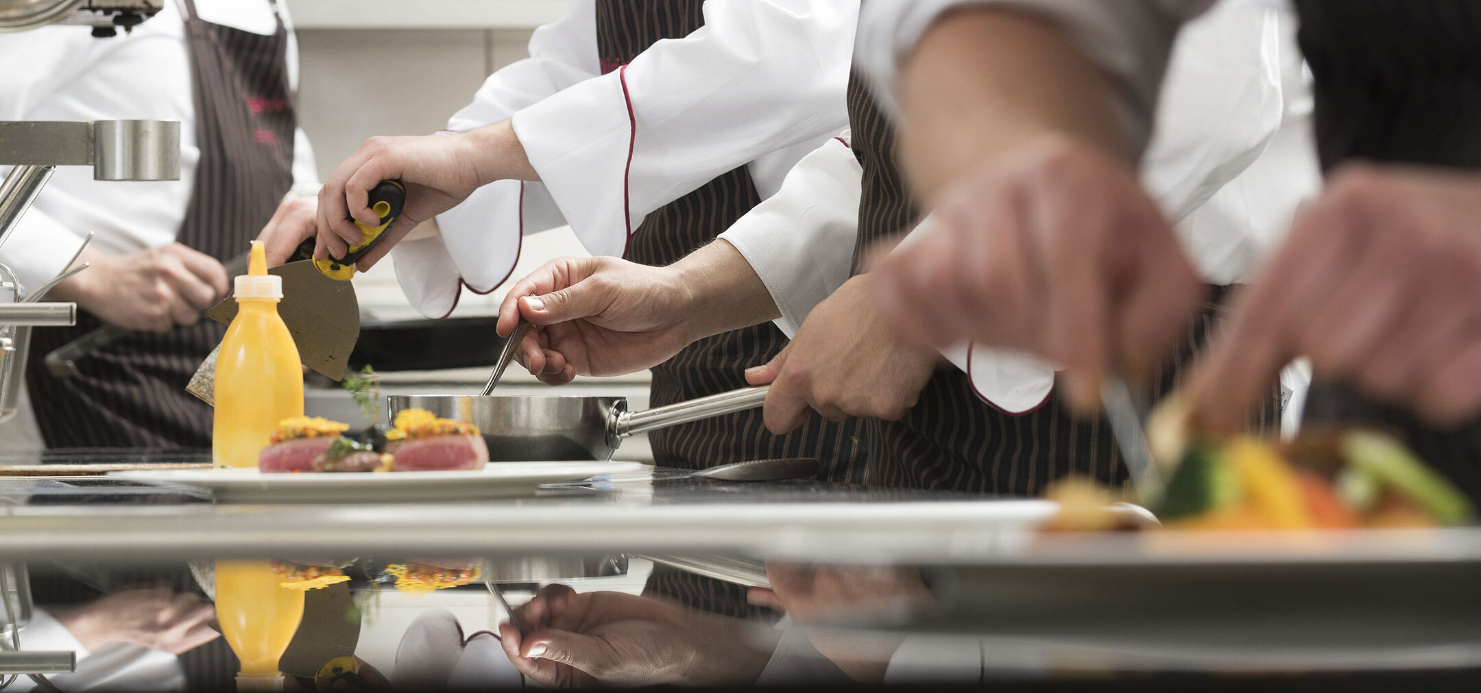 Kitchen team at work Chefs preparing gourmet dishes in the kitchen of the Orangerie at Maritim Seehotel Timmendorfer Strand.