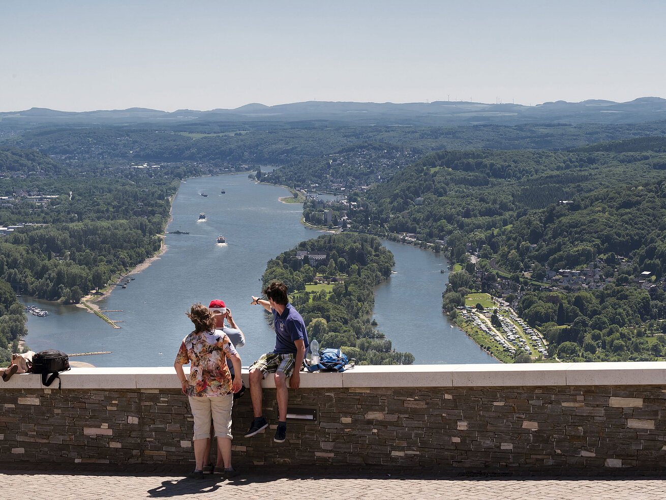 View into the Rhine Valley Visitors enjoy the breathtaking view from Drachenfels over the Rhine and surrounding forests.